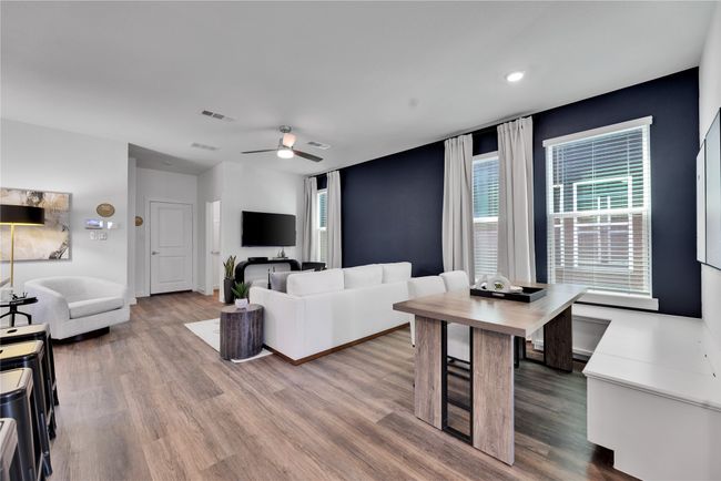Living area featuring plenty of natural light, wood finished floors, and visible vents | Image 8