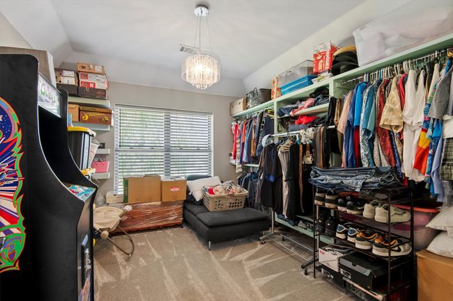 Originally a bedroom, now a walk-in closet featuring a chandelier, carpet floors, and lofted ceiling. Can be turned back into bedroom. | Image 28