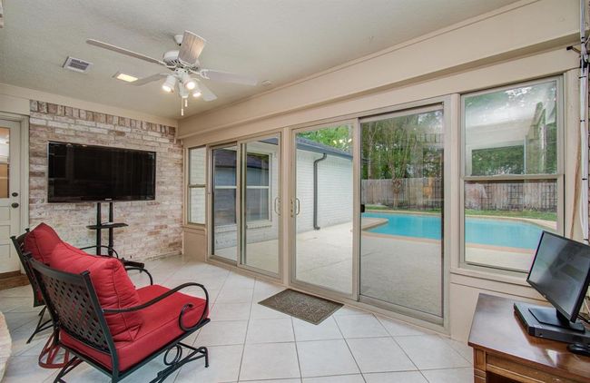 This sunroom is the perfect place to enjoy your morning coffee and enjoy the view. | Image 18