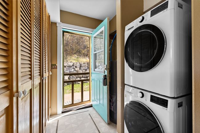 Laundry area with stacked washer and dryer and laundry area | Image 27