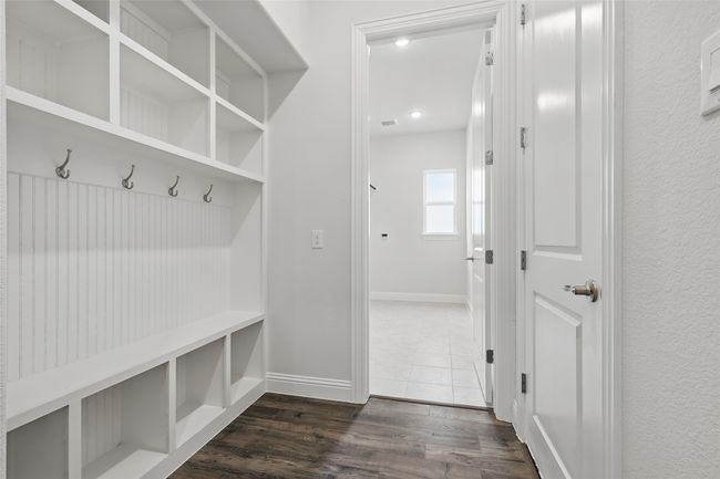Mudroom with baseboards, visible vents, and dark wood-type flooring | Image 32