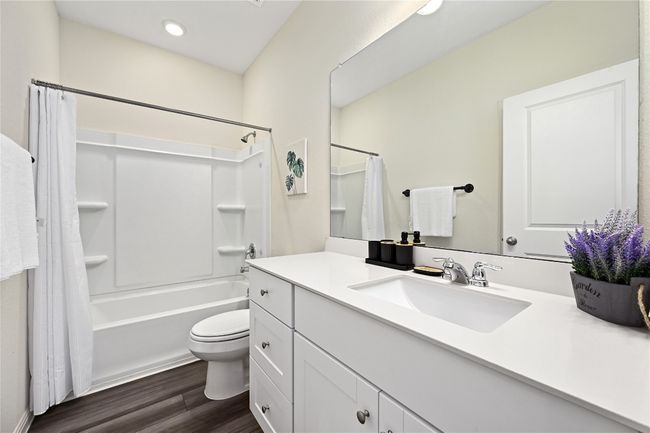 Full bath with recessed lighting, wood finished floors, toilet, vanity, and shower / tub combo with curtain | Image 26