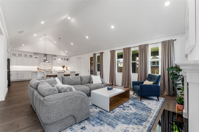 Living area featuring dark wood finished floors, high vaulted ceiling, and recessed lighting | Image 20