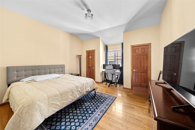 Bedroom featuring light wood finished floors, vaulted ceiling, and baseboards | Image 14