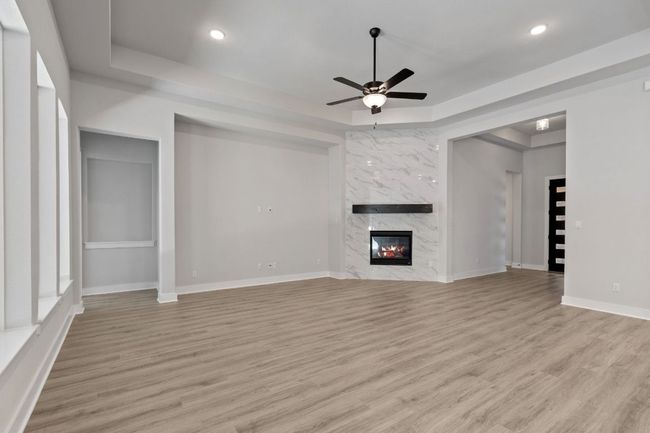 Family Room with tray ceiling & fireplace | Image 15
