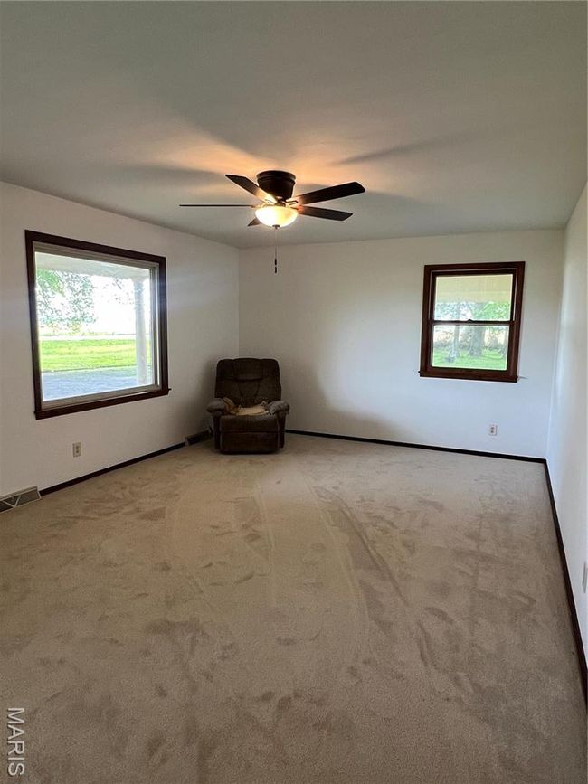 Unfurnished room featuring baseboards, carpet flooring, visible vents, and a ceiling fan | Image 17