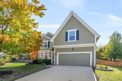 View of front of house featuring a front lawn and a garage | Image 2