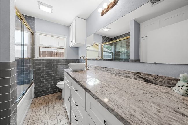 Huge full bath off the main hallway with tub and shower! High end look and tons of storage! | Image 16
