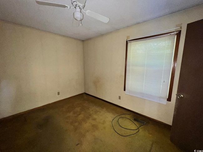 Empty room featuring ceiling fan, carpet, and baseboards | Image 14