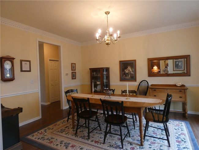 The dining room features chair rail and crown molding | Image 16