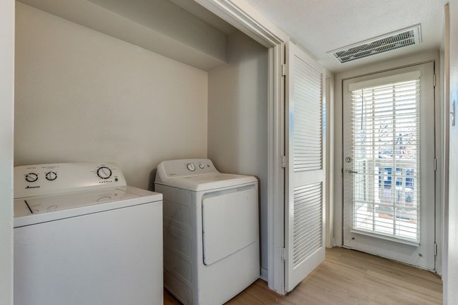 Washroom featuring light hardwood / wood-style floors and washer and clothes dryer | Image 24