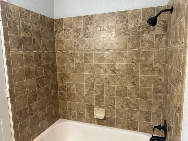 Bathroom featuring shower / bathing tub combination | Image 12