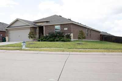 Ranch-style home with a garage and a front yard | Image 3