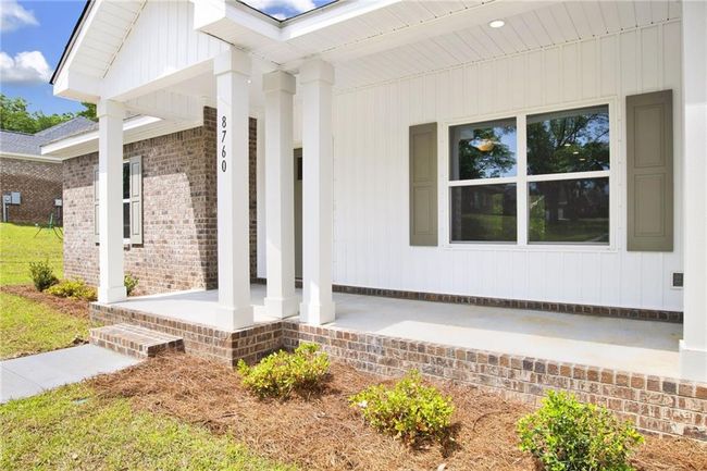 Property entrance with covered porch and brick siding | Image 8