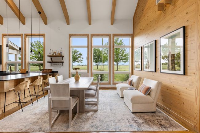 Dining area with beamed ceiling and wood walls | Image 16
