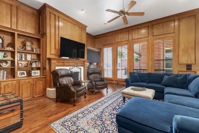 Living area featuring a healthy amount of sunlight, lwood-type flooring, and wooden walls | Image 10