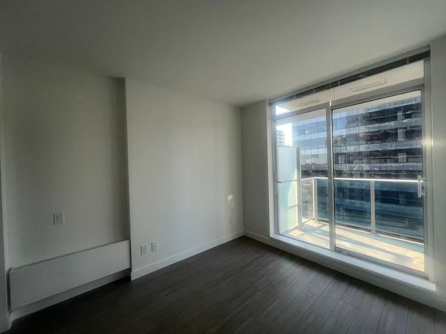 Unfurnished room with dark wood finished floors and baseboards | Image 14