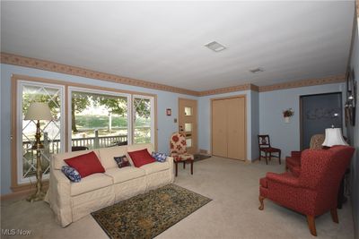 Carpeted living room featuring plenty of natural light | Image 3