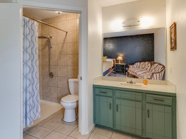 Full bathroom featuring tile patterned floors, vanity, a tile shower, and a textured ceiling | Image 29