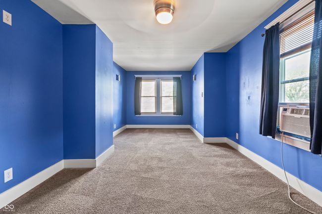 carpeted empty room featuring baseboards and cooling unit | Image 41