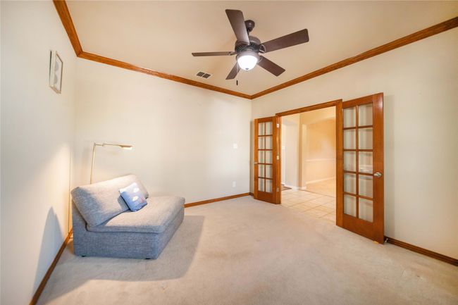 Sitting room featuring french doors, crown molding, carpet flooring, and a ceiling fan | Image 6