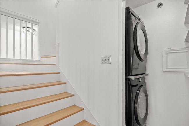 Laundry area with estacked washer and dryer | Image 14