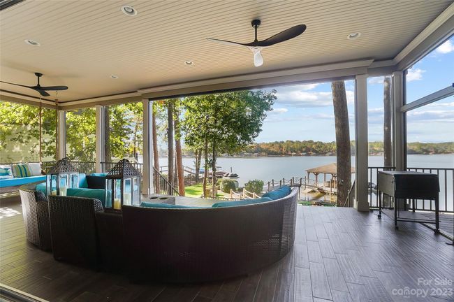 You’ll spend hours lingering over morning coffee, reading a book, or relaxing & enjoying the impressive lake views from the fabulous covered patio | Image 31