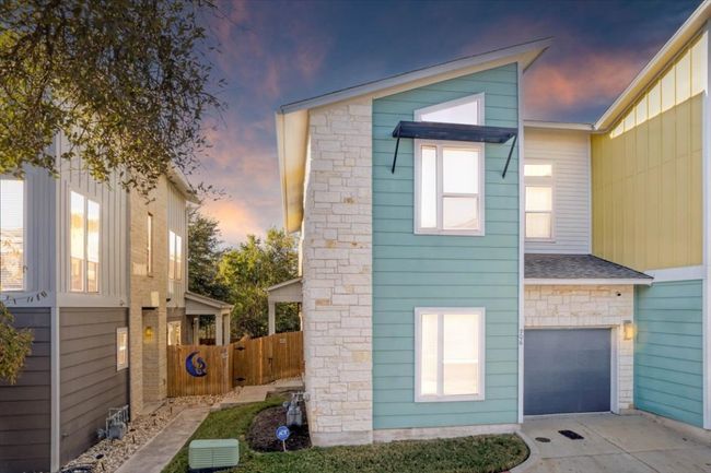 The modern exterior of this end-unit condo also includes an attached garage! | Image 8