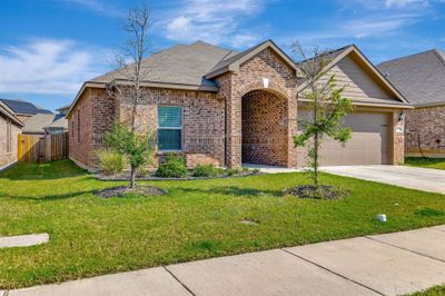 View of front of home featuring a garage and a front lawn | Image 1