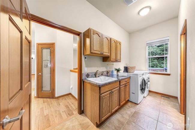 Laundry room on the main level with a third bathroom to the right | Image 20