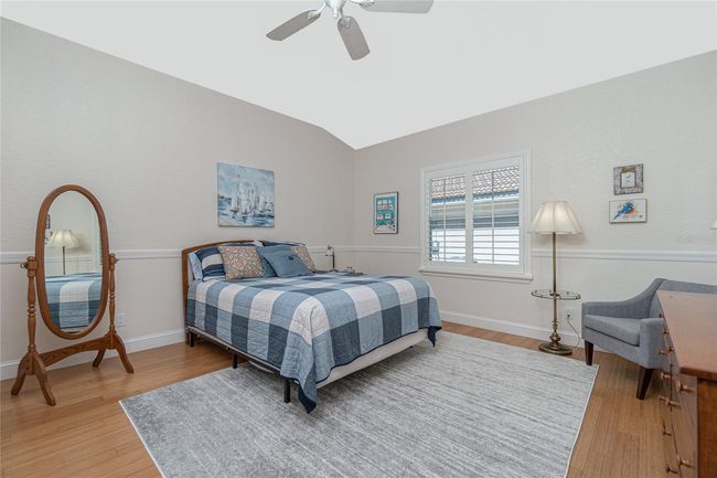2nd guest bedroom with volume ceilings, bamboo flooring & plantation shutters | Image 49