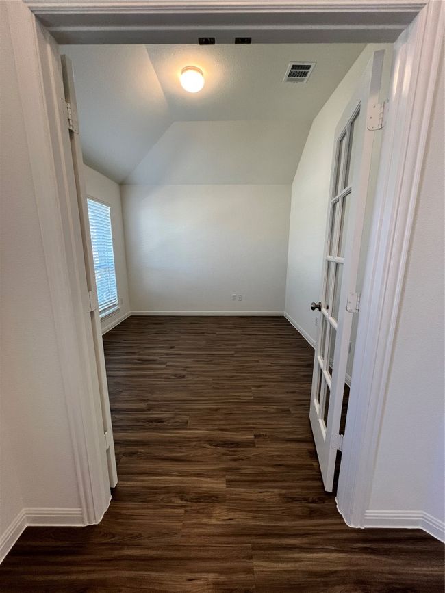 Additional living space featuring lofted ceiling, dark wood-type flooring, and french doors | Image 7