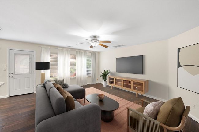 Living area featuring a ceiling fan and dark wood-type flooring | Image 9