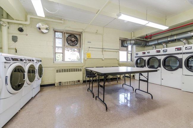 Communal laundry room with washing machine and dryer and radiator heating unit | Image 15