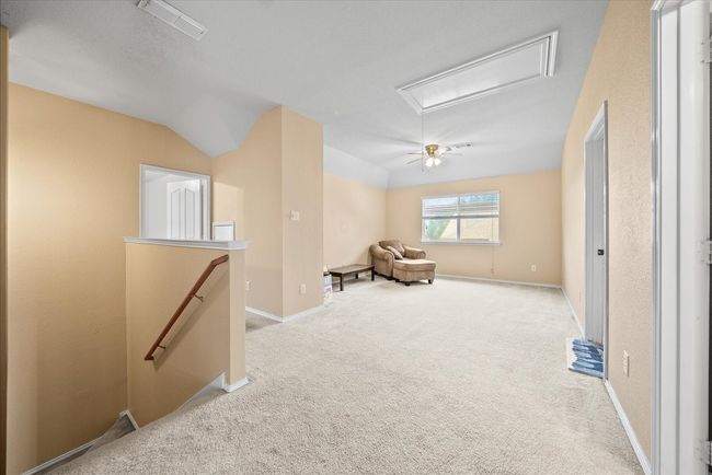 Corridor featuring attic access, an upstairs landing, carpet floors, baseboards, and vaulted ceiling | Image 30