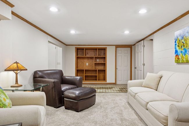 Lower level built-in entertainment center with shelving | Image 22