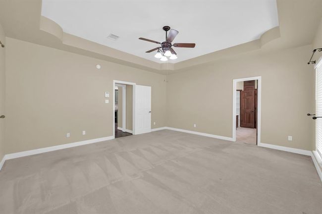 Primary Bedroom. Door on the left goes to the DiningRoom, and the door on the right leads to the Primary Bathrrom. | Image 22