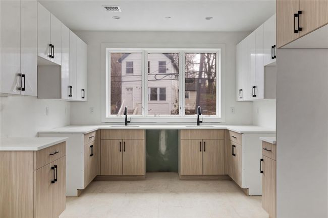 Kitchen with dishwasher, a sink, visible vents, and light countertops | Image 17