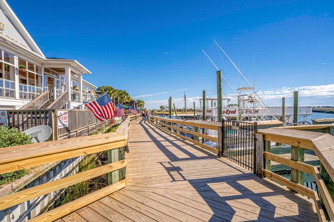 Dock featuring a water view and stairway | Image 36