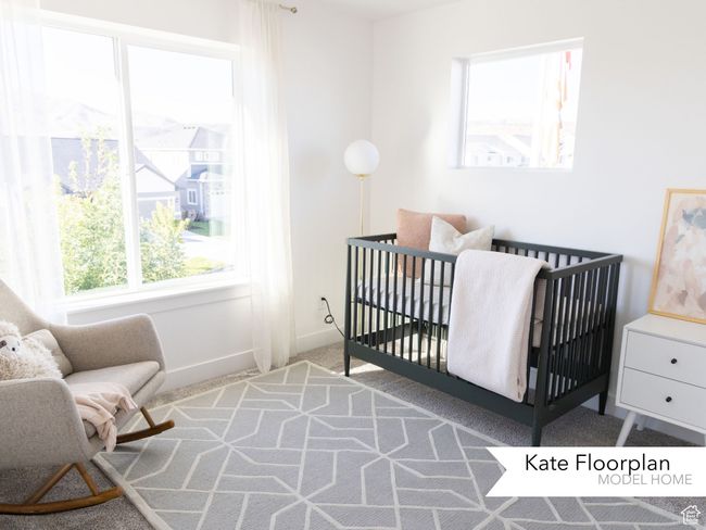 Bedroom with carpet flooring, baseboards, and a crib | Image 11