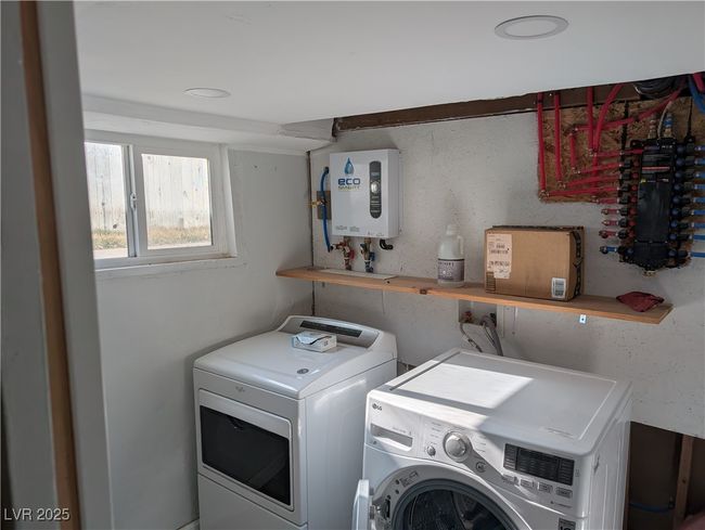 Clothes washing area with water heater, laundry area, and washing machine and clothes dryer | Image 22