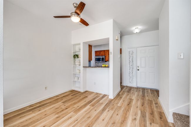 Dining area has built-in shelves, pass-through granite countertop to kitchen. | Image 5