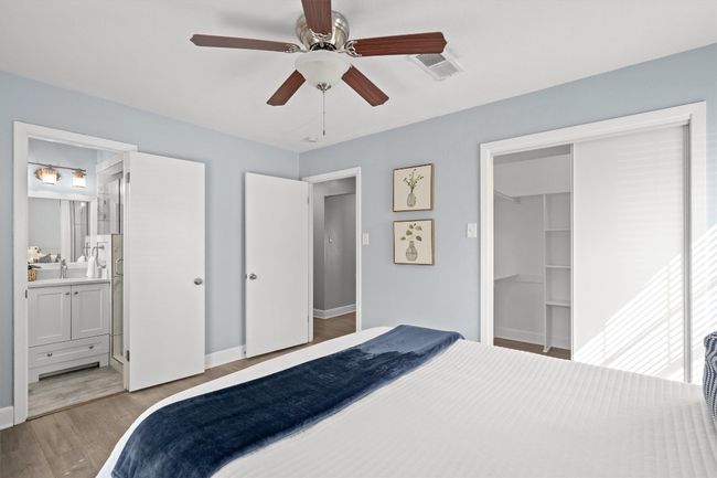 Bedroom with a sink, ensuite bath, a closet, light wood-style floors, and baseboards | Image 19