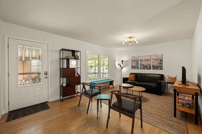 The home is filled with natural light from large windows and glass front doors. | Image 4