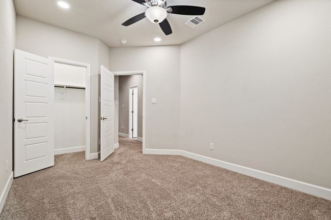 Unfurnished bedroom featuring light colored carpet, recessed lighting, a ceiling fan, and a closet | Image 21