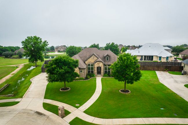 French country inspired facade with stone siding and concrete driveway | Image 30