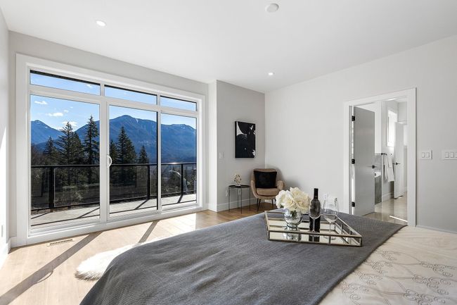 Bedroom with a mountain view, access to outside, wood finished floors, baseboards, and recessed lighting | Image 16
