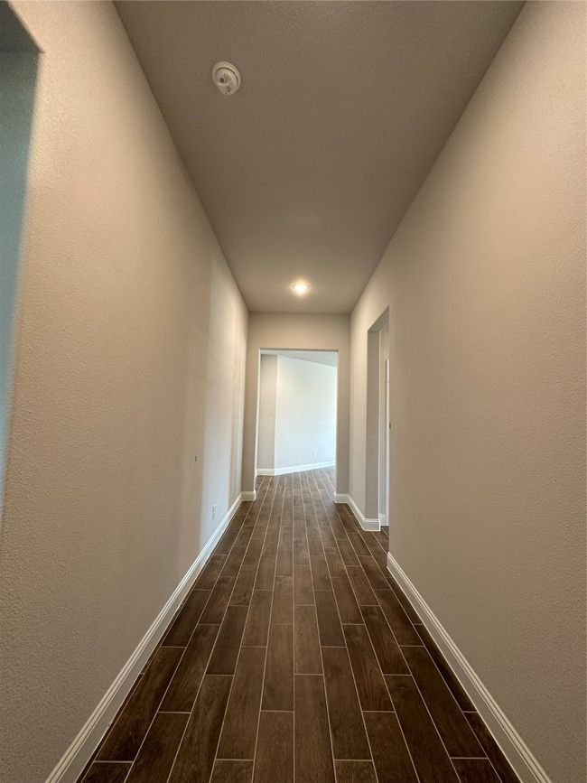 Hall featuring dark wood-style flooring and baseboards | Image 11
