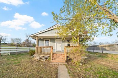 Bungalow-style house with a front lawn and a porch | Image 1