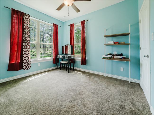 Sitting room with carpet flooring and ceiling fan | Image 33